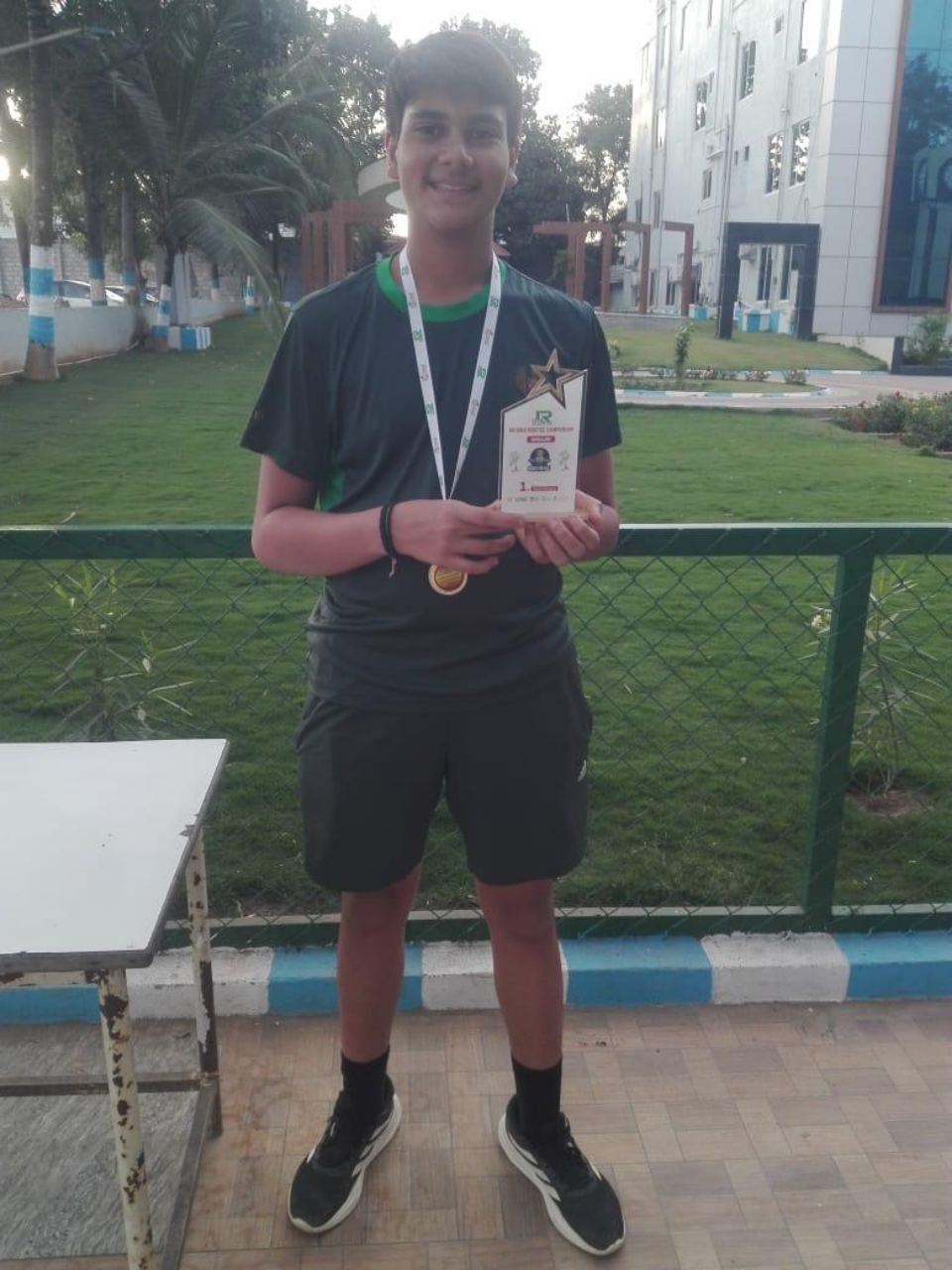 Pranay with a first-place robotics championship trophy