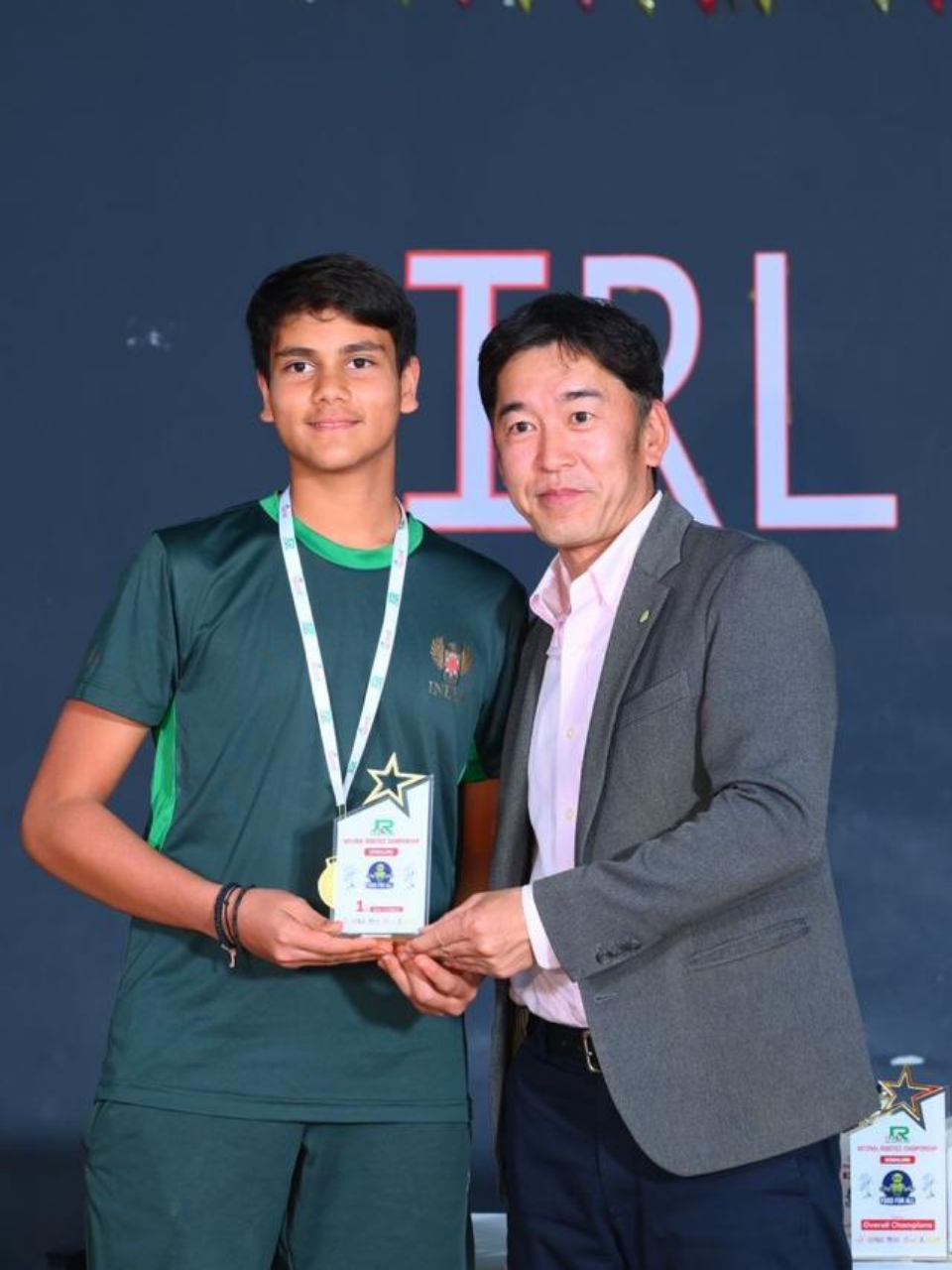 Pranay receiving a robotics championship award on stage